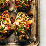Loaded BBQ Baked Potatoes on a sheet pan.