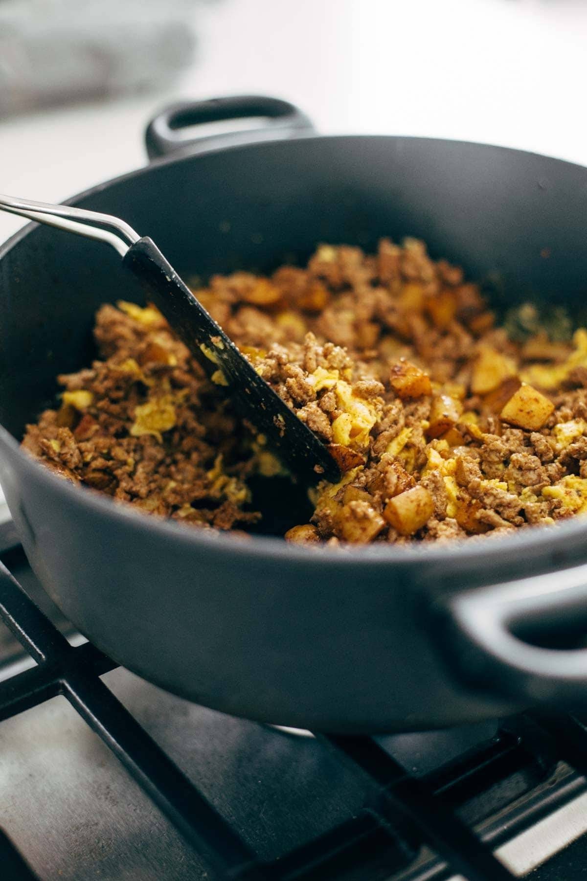 turkey and potatoes in a pan on the oven