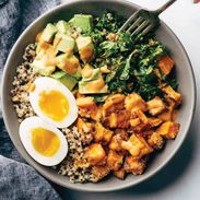 White hand with a fork digging into Chipotle Tahini Bowls