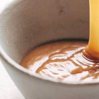Vegan Caramel Sauce poured into a bowl.