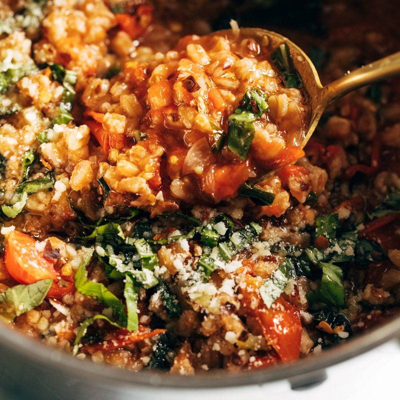 Stewed farro and veggies in a large pot.