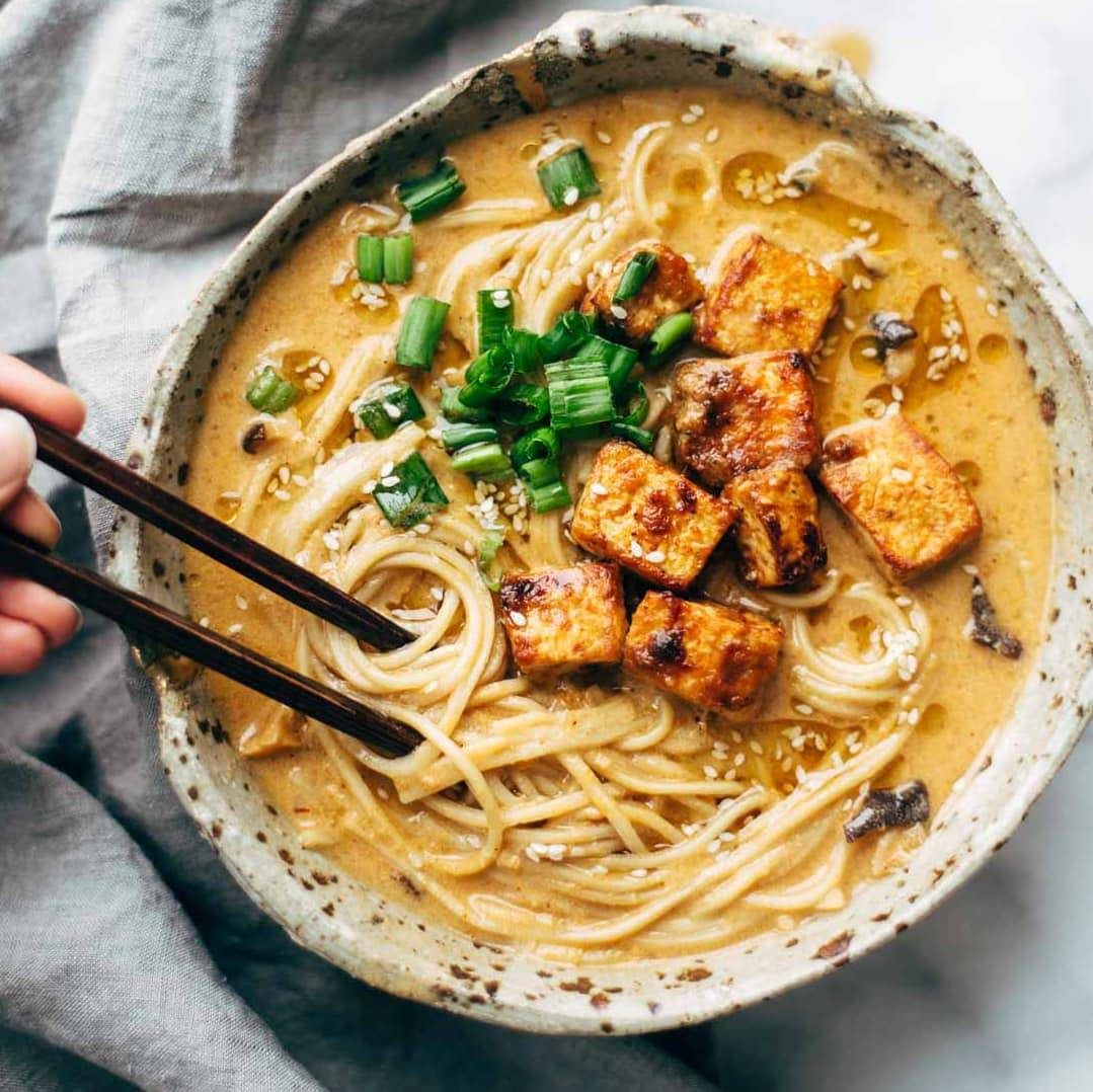 Spicy ramen in a bowl topped with tofu.
