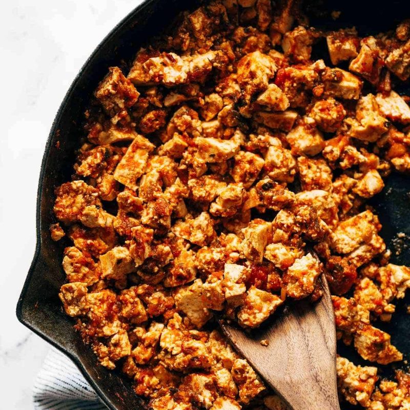 Sofritas in a skillet with a wooden spoon