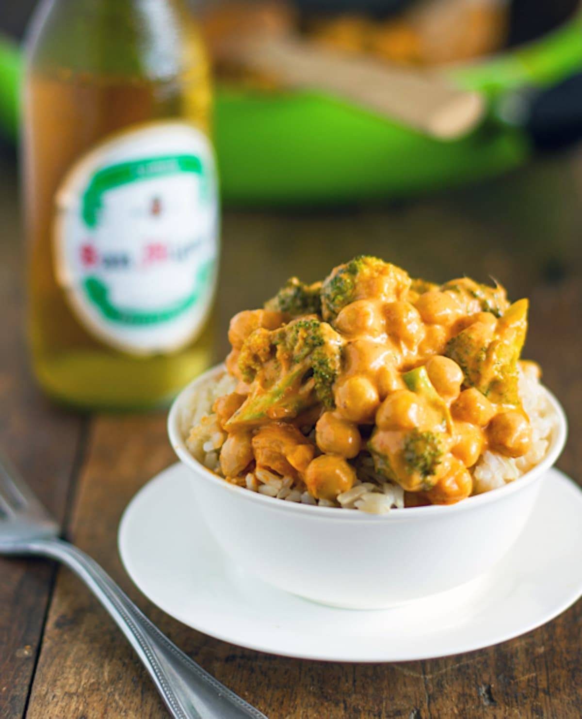 Coconut curry with broccoli and chickpeas and a creamy coconut curry sauce in a white bowl.